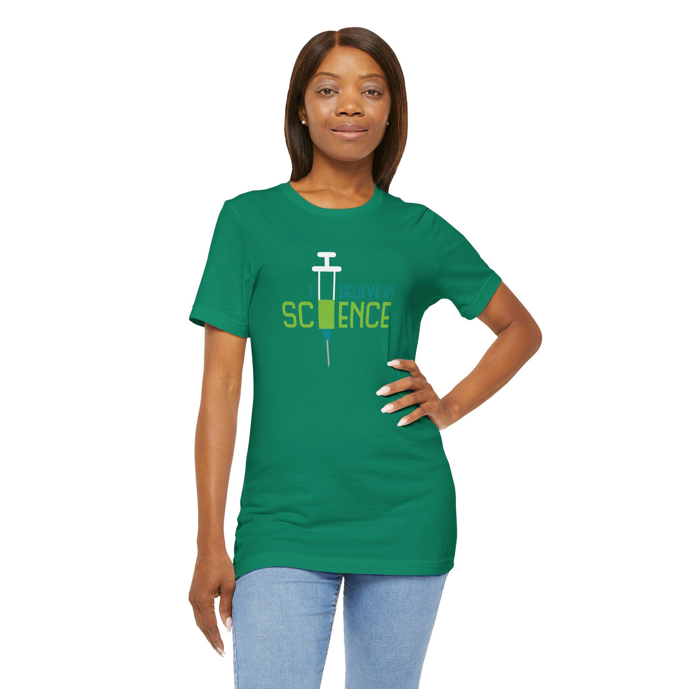 Woman wearing a green t-shirt with 'I Believe in Science' text and syringe graphic 