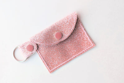 Pink glittery pouch with a keychain tab