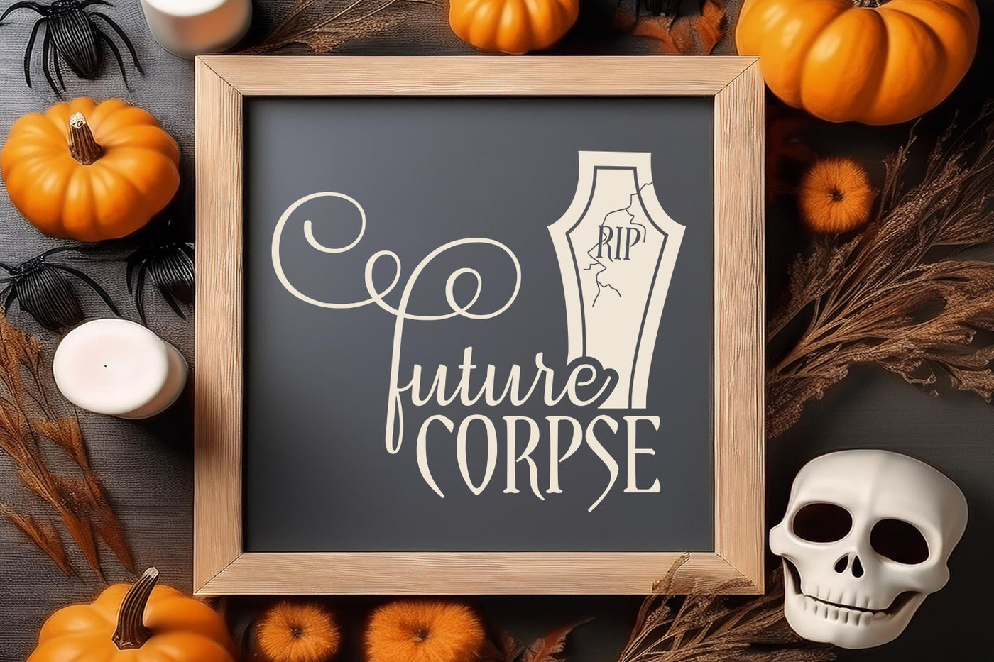 Framed sign with 'RIP future CORPSE' text with a headstone. Frame is surrounded by Halloween decorations on a wooden surface.