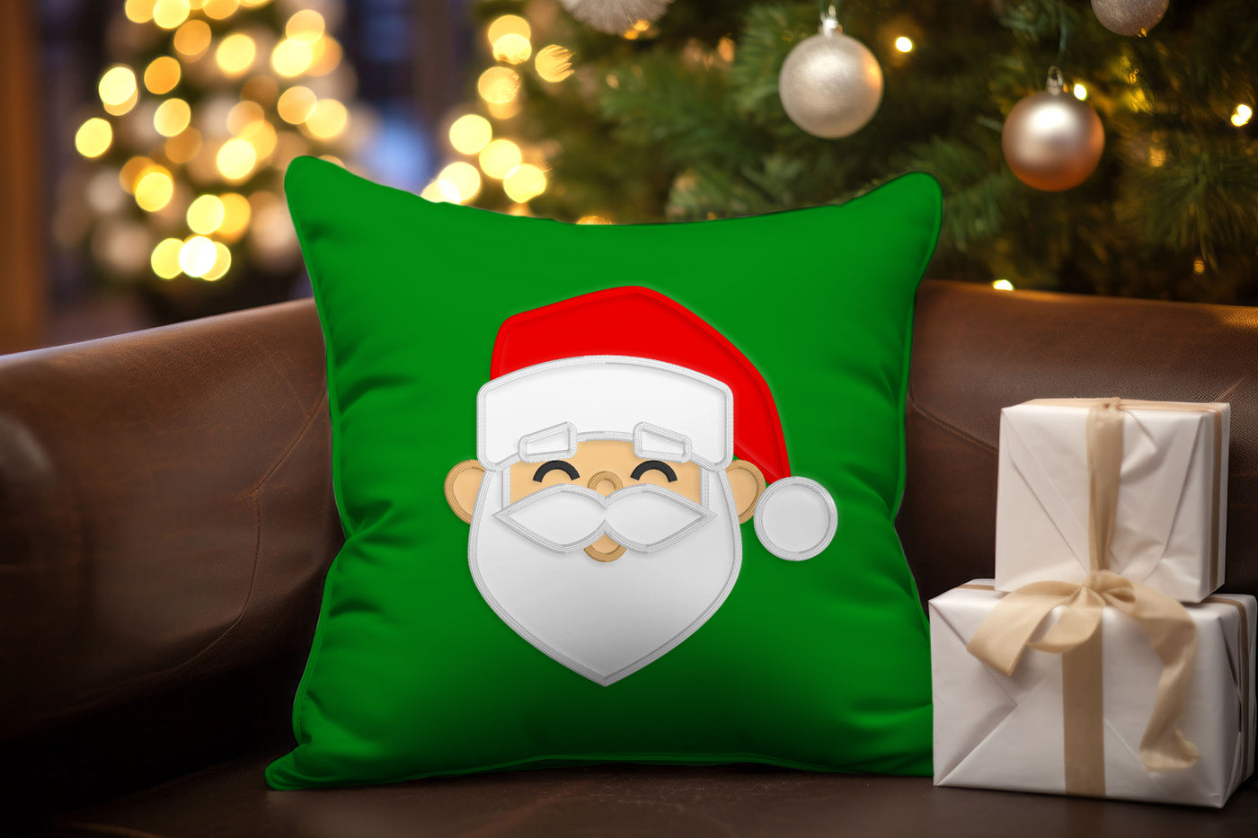 Green pillow with Santa face applique design on a couch with Christmas decorations