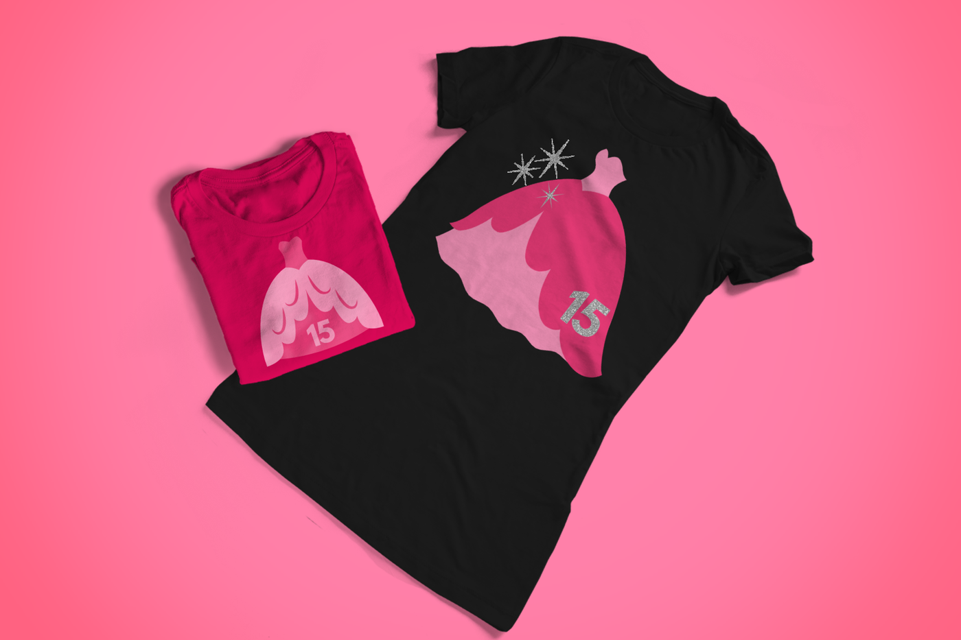 Two tees on a pink background. Each has an image of a fancy ballgown with the number 15. One is from a front view, and the other has the gown shown slightly from the side.