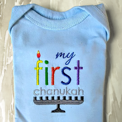 Embroidery designs of a menorah that says "my first chanukah." The F looks like a candle.