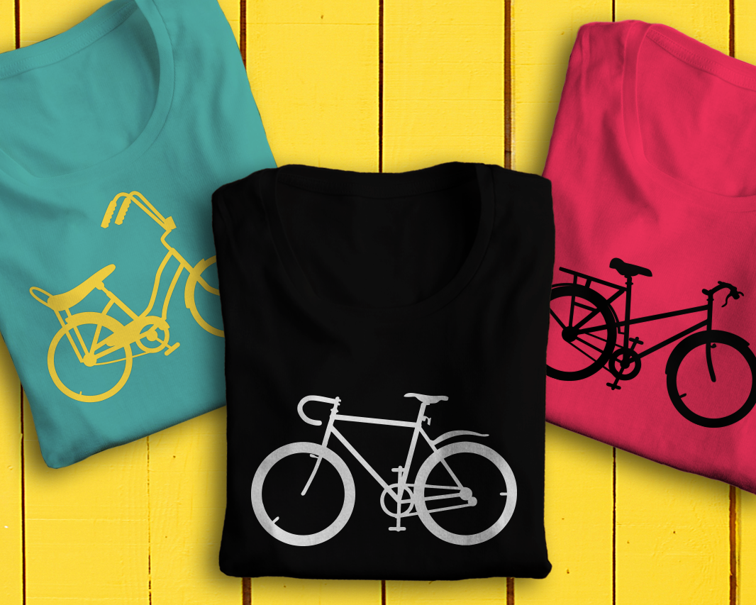 3 folded shirts, each with a different bicycle silhouette design.