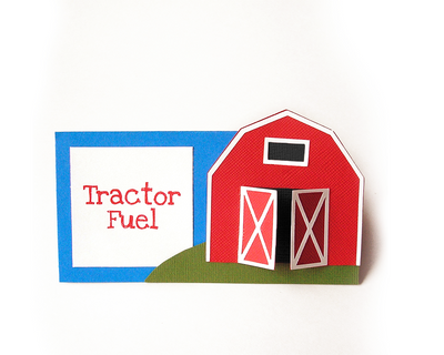 A table tent with a paper barn with doors that swing out. The tent is labeled "Tractor Fuel."
