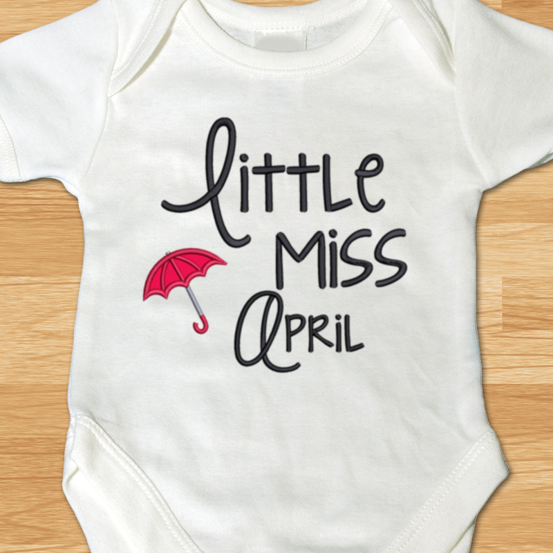 Little miss April applique design with an umbrella.