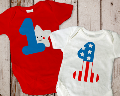 Two baby onesies. One has a large 1 with a smiling star behind it. The other has a large 1 with stars and stripes.