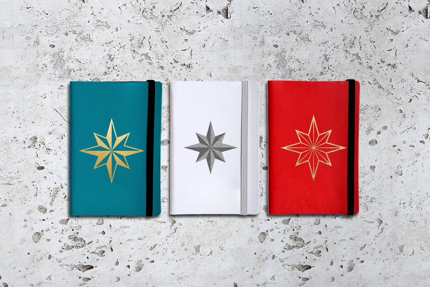 Three notebooks on a cement background. Each features an 8-pointed dimensional star design.
