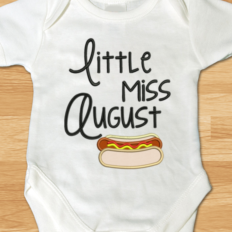 Little miss August applique design with a hot dog.