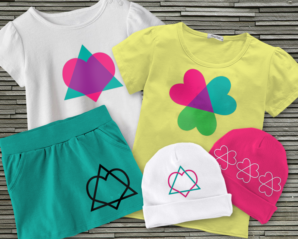 A collection of children's clothing in bright colors. Each features a heart and triangle design to represent adoption.