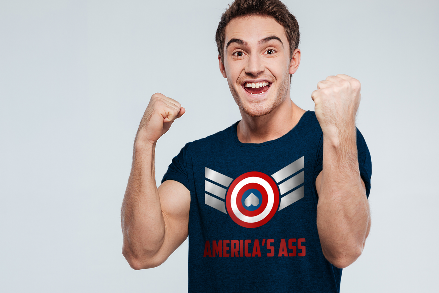 Excited white man wears a shirt that says "America's Ass." There is a target symbol with stripes angling out from each side and an upside down heart in the middle.