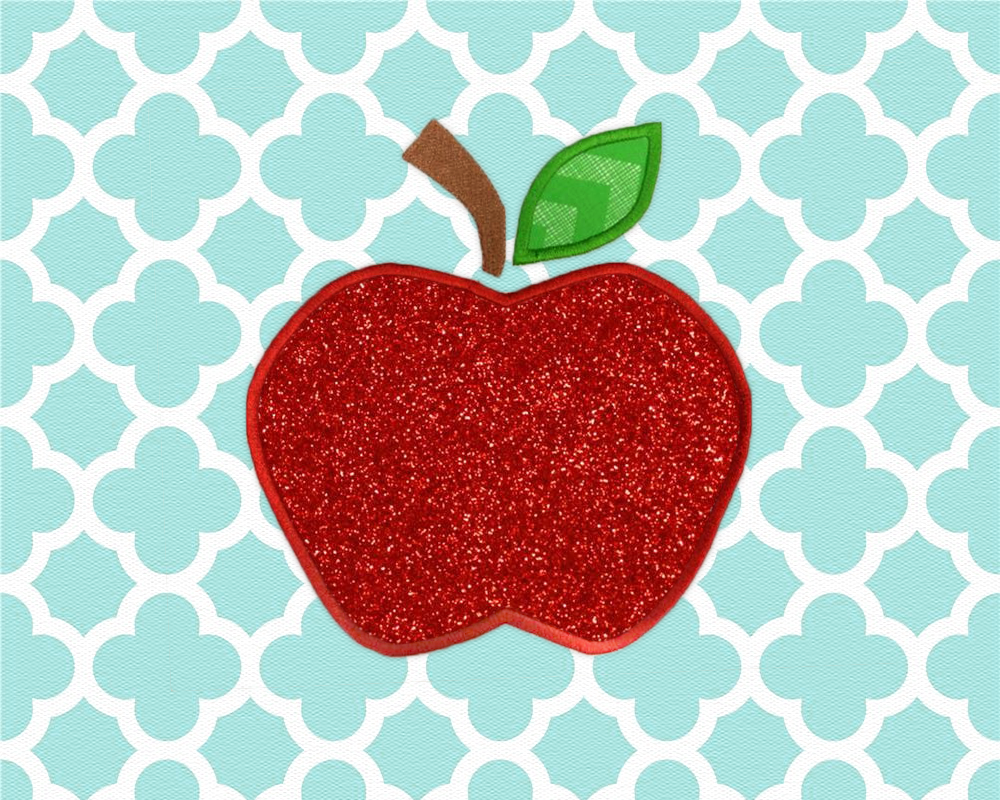 Aqua and white quatrefoil fabric is embroidered with an applique apple made out of glittery red fabric.