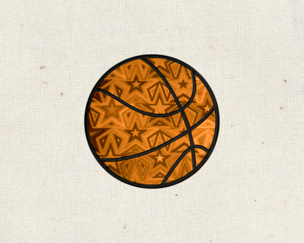 An applique basketball is on a piece of muslin fabric. The applique fabric is orange with brown stars.