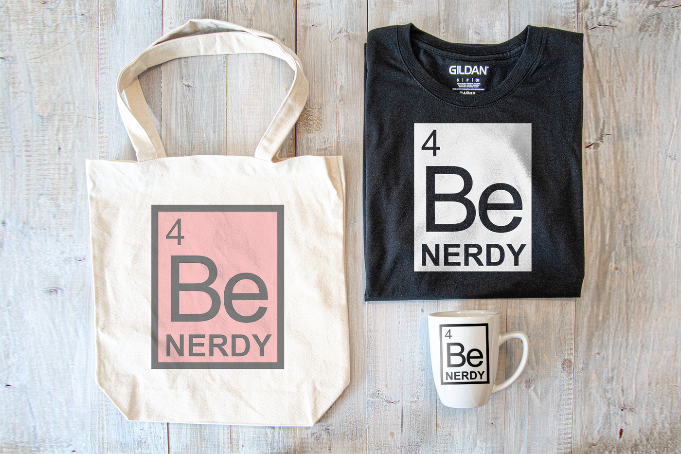 A chemical symbol has the words "Be Nerdy." SVG design is shown in 1 and 2 color variations on a shirt, tote, and mug.