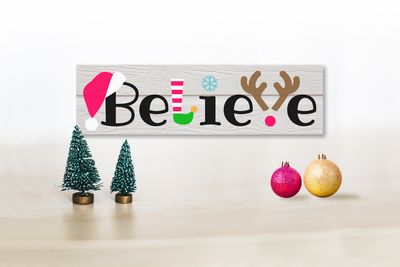 Believe sign with Christmas icons incorporated into the words.