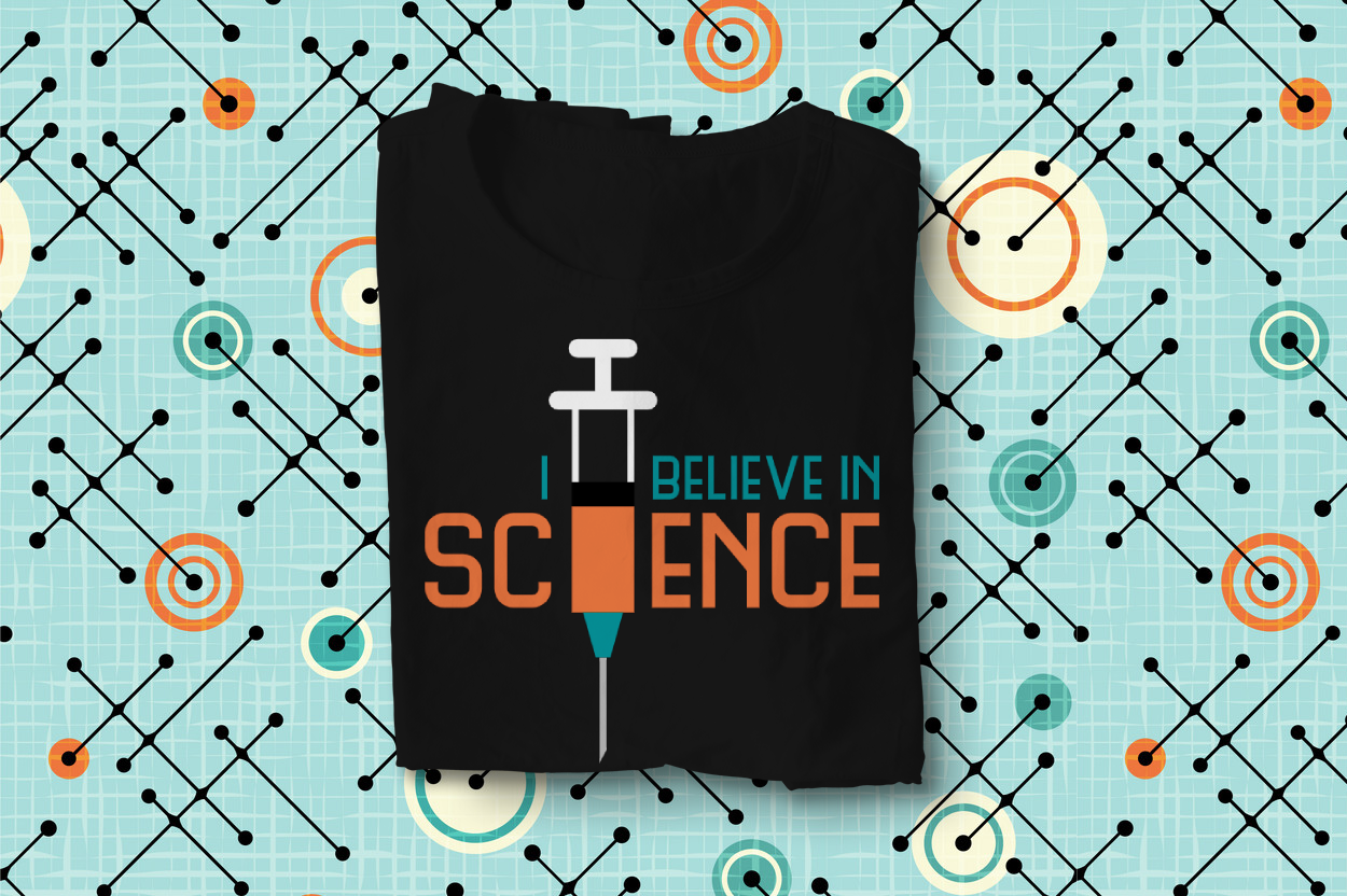 Folded tee says "I believe in science" with a syringe.