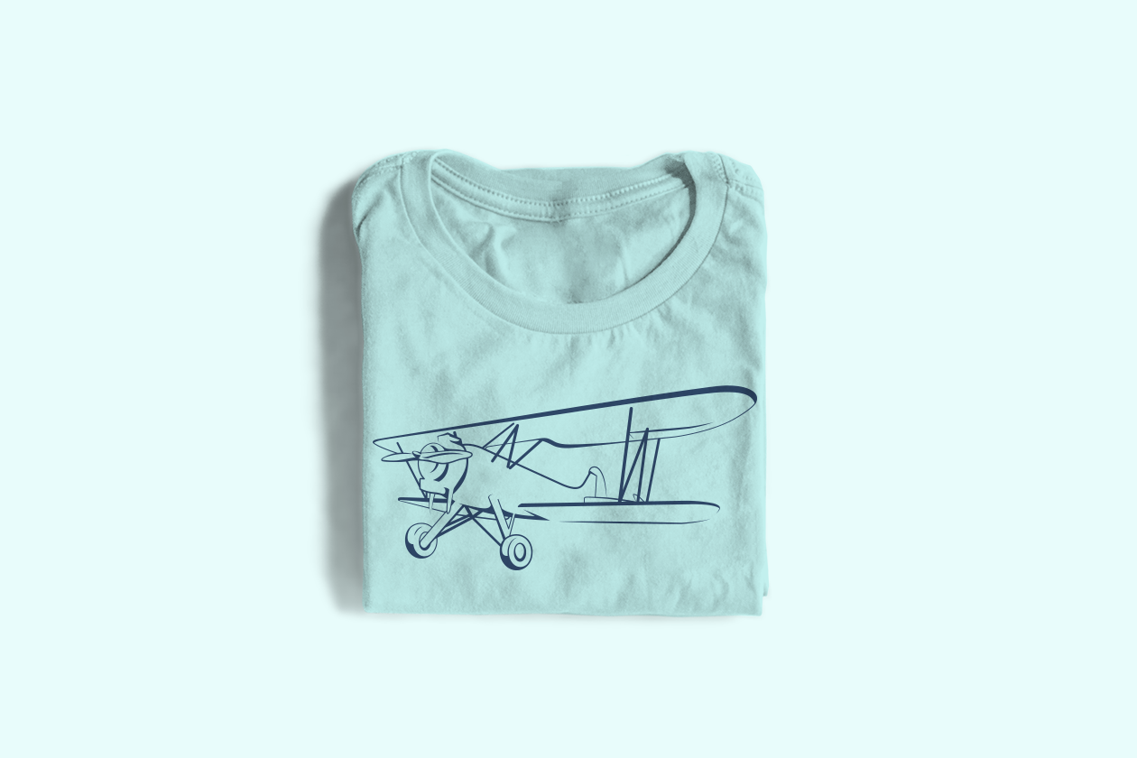 A folded blue shirt with a stylized illustration of a biplane.