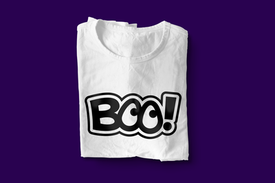 A white shirt on a purple background with the word "BOO!" in black and white with an offset outline. The Os look like eyes.