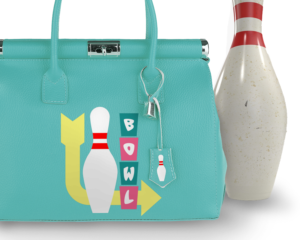 An aqua purse with a bowling pin next to it. Decorating the purse is a retro style sign in pink and turquoise that says "BOWL" with a large yellow arrow and bowling pin.