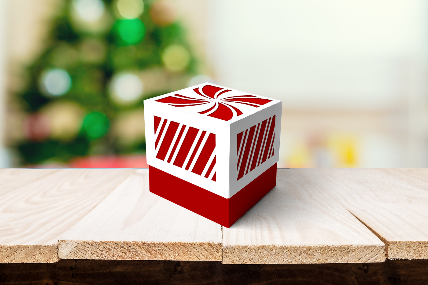 Cube shaped gift box with candy cane stripe cutouts on the lid.