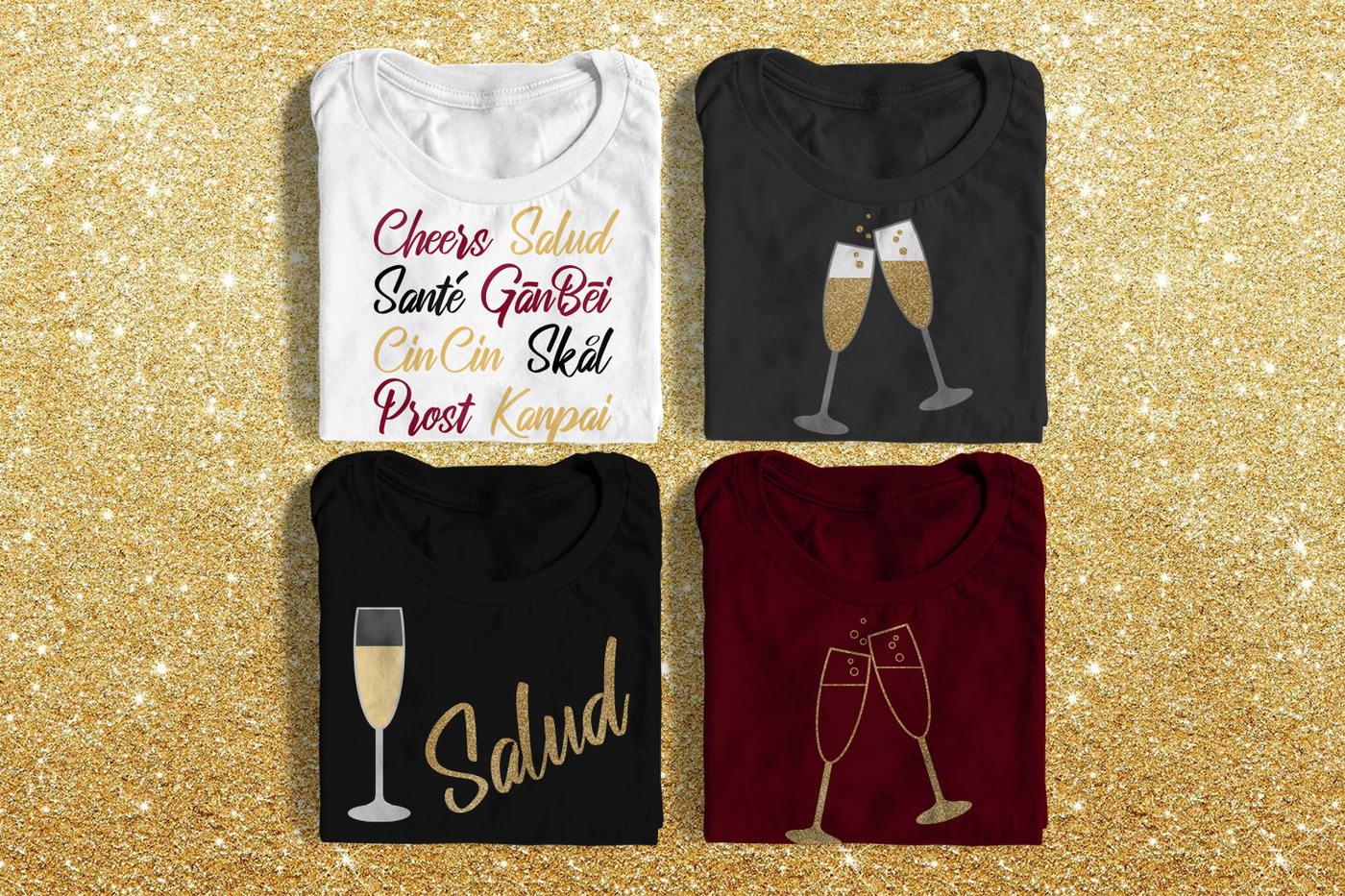 Four folded tees on a glittery gold background. One tee has the words Cheers, Salud, Sante, Gan Bei, CinCin, Skal, Prost, and Kanpai. Two tees have toasting champagne flutes, one in a single color design, the other as a multi-color design. The last tee says "Salud" with a filled champagne glass.