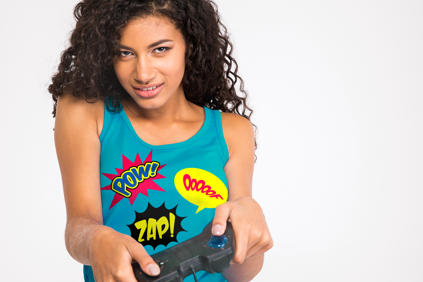 A woman of color holds a video game controller with a determined look. She wears a turquoise tank top with comic book style outbursts that say "Pow!" "Zap!" and "Ooooof."