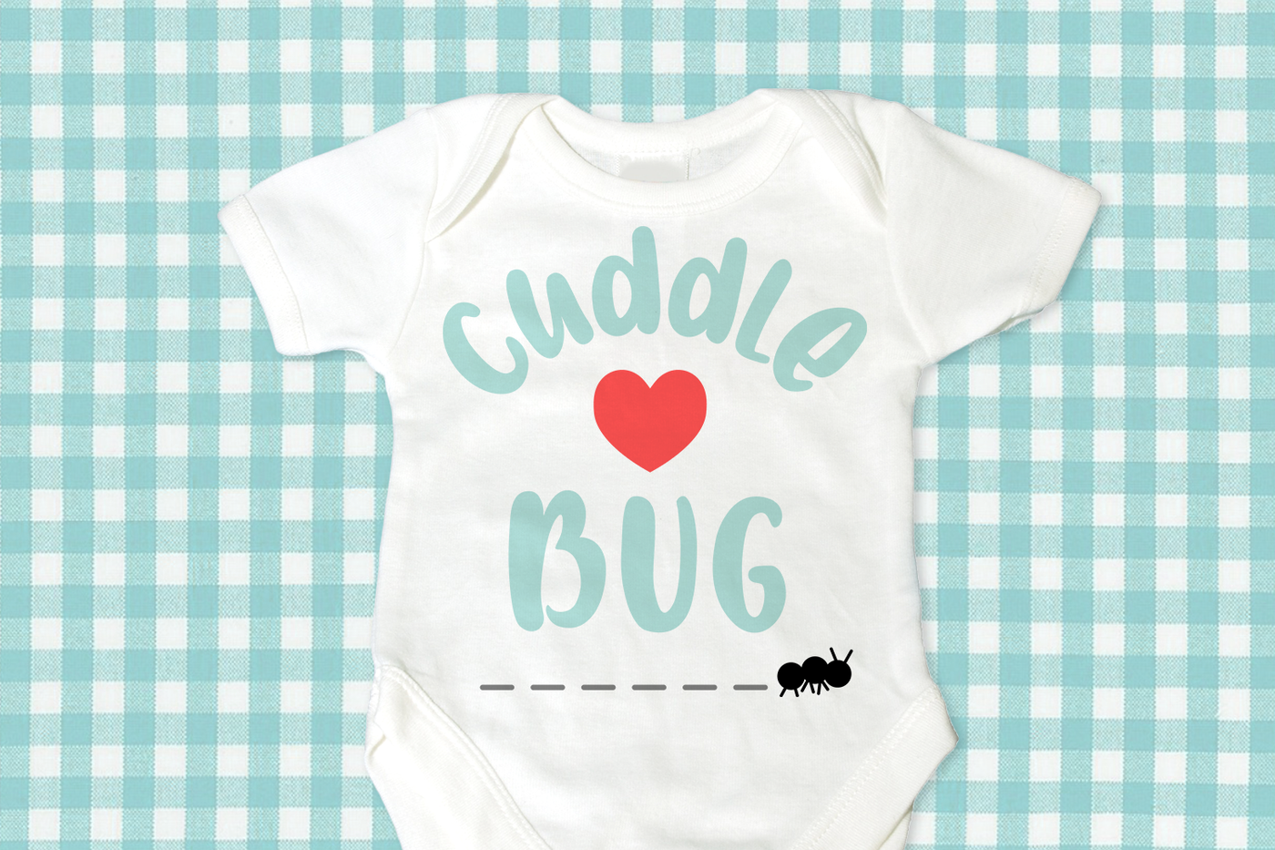 Cuddle bug SVG design with a heart in the middle and an ant walking along the bottom. Shown on a baby bodysuit.