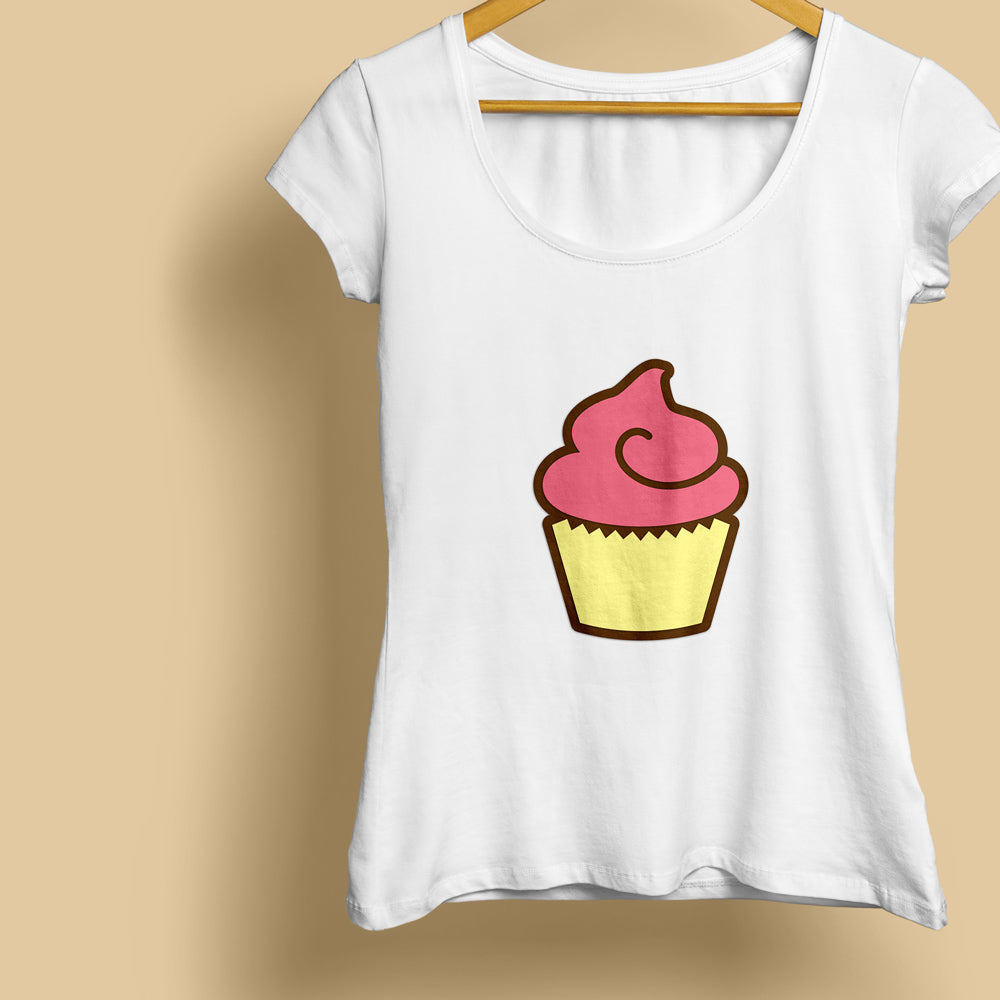 A white shirt hanging from a hanger. On the shirt is a pink frosted cupcake with a yellow wrapper and brown offset outline.