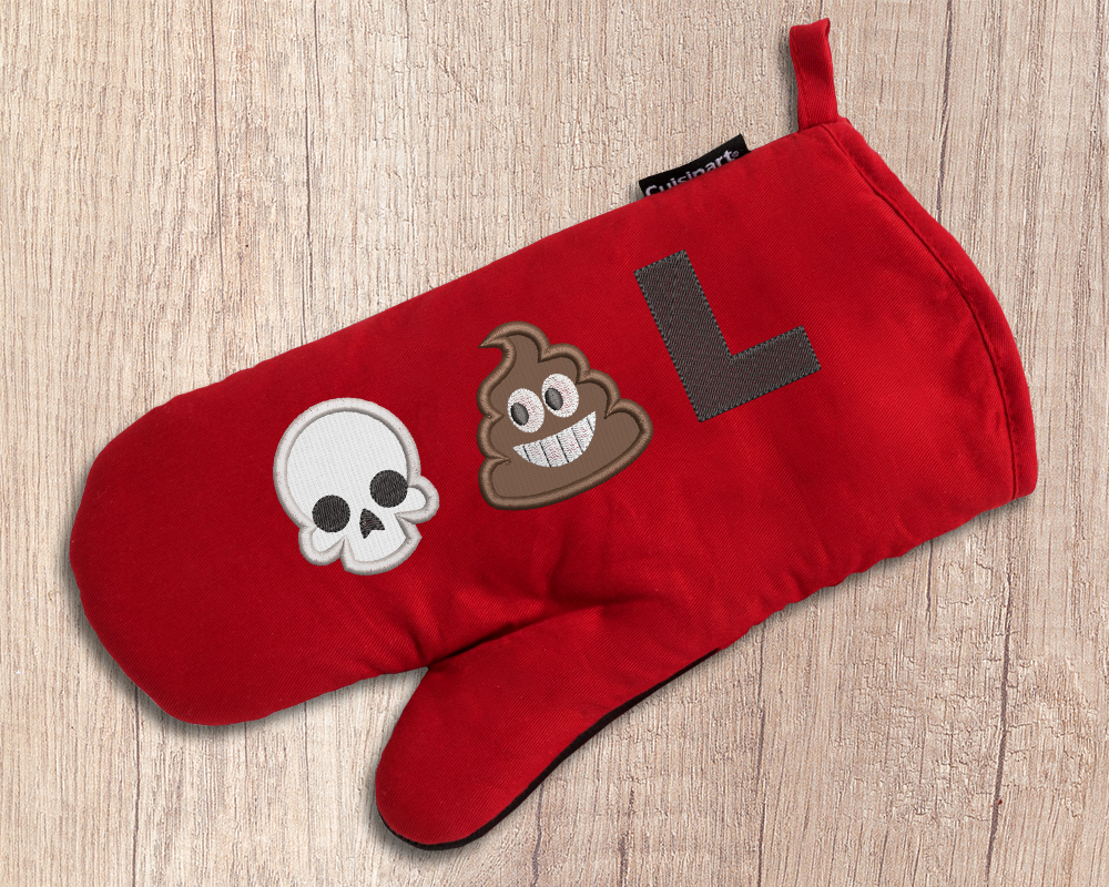 A red oven mitt with an applique skull emoji, applique poop emoji, and embroidered letter L.