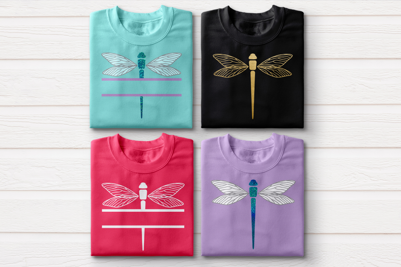 Four folded sweatshirts. Two have dragonflies, and two have dragonflies with splits in the middle. One of each is done in a single color, and one of each is done as a multicolor design with glitter vinyl for the bodies.