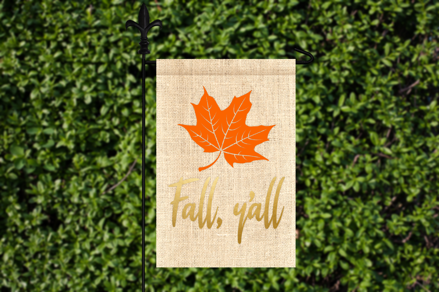 A burlap yard flag with a maple leaf design and the phrase "Fall, y'all"