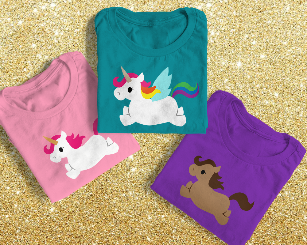 Three folded tees. One has a unicorn, one has a Pegasus, and one has a horse.