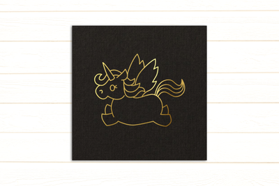 Line drawing of a unicorn in gold foil on a black card.