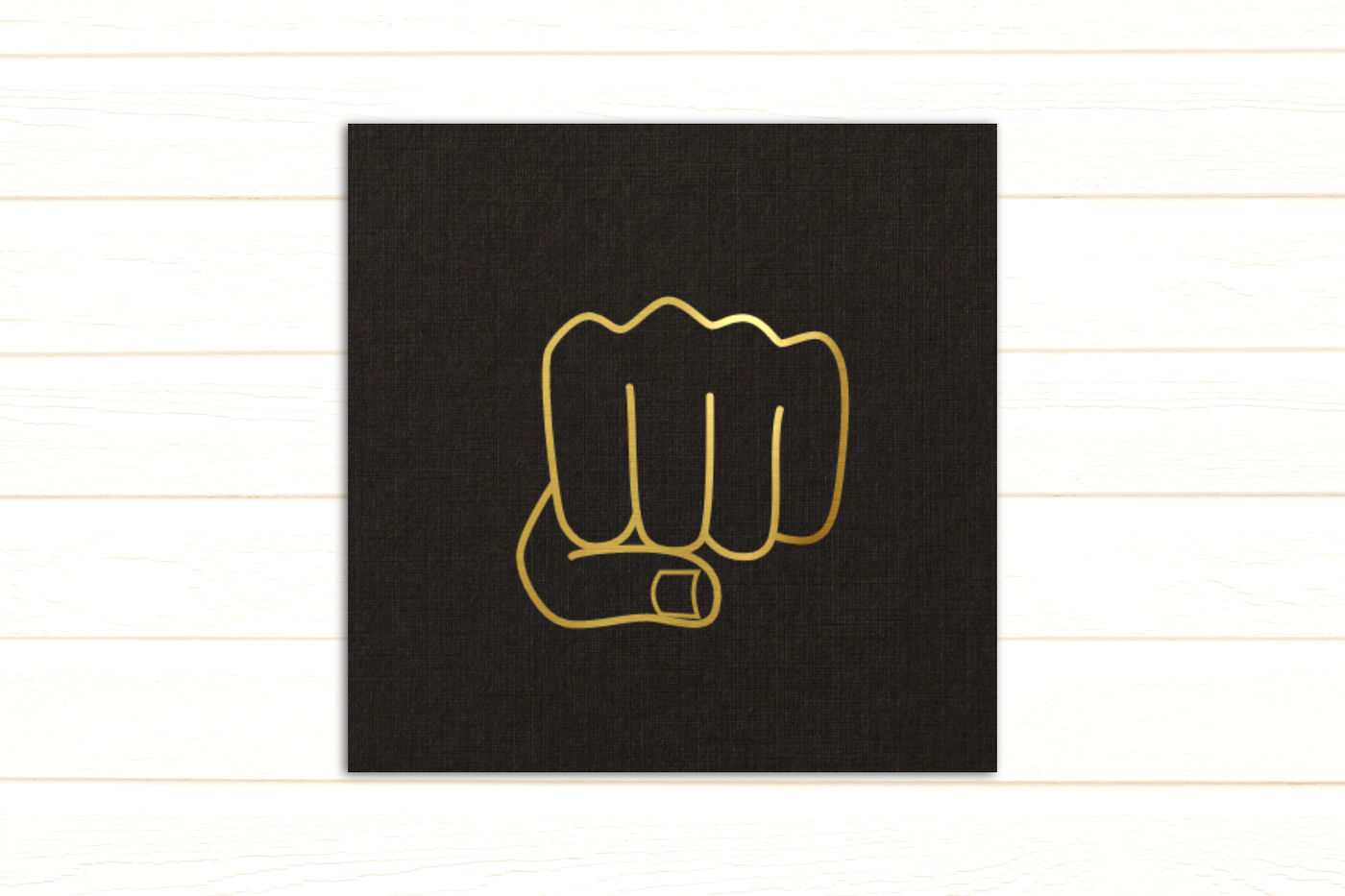 Line drawing of a pair of fists done in gold foil.