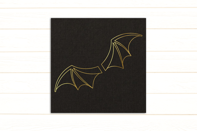 A black card with gold bat wings on it