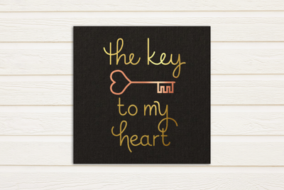 Single line sketch design that says "the key to my heart" with a heart shaped skeleton key. Done in gold and copper foil.