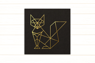 A black card with a gold line drawing of a geometric fox.