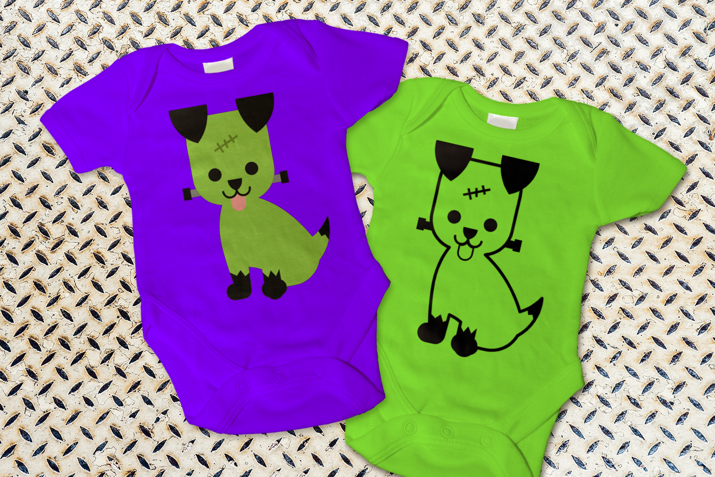 Two baby onesies, each with a puppy that is dressed up like Frankenstein's monster.