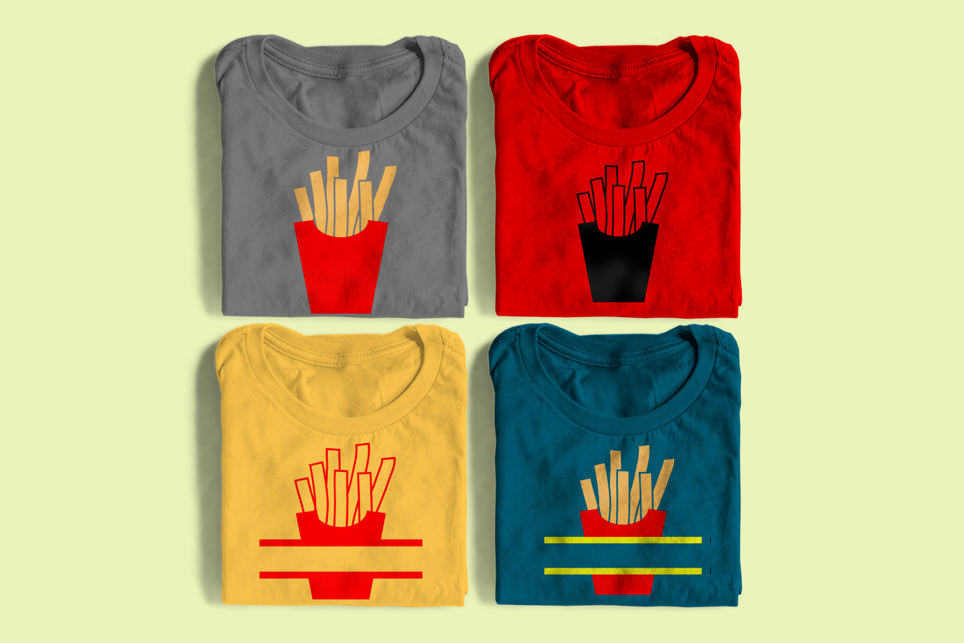 Four folded shirts, each has an image of a french fry container. Half are in single color, half are multicolor. Two have splits in the middle.