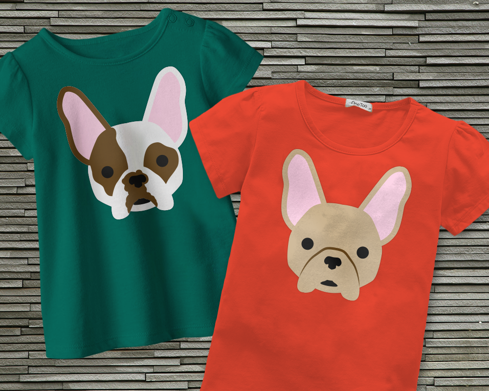 Two shirts, each with a french bulldog face design. One has markings on their nose, eyes, and one ear.