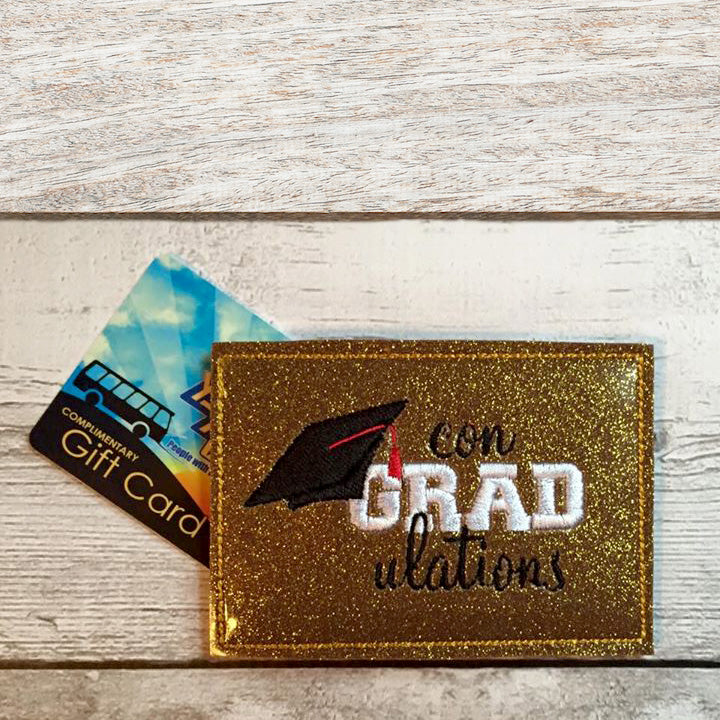 Gift card holder made out of gold vinyl. It says "con-GRAD-ulations" with a grad cap hanging from the G.