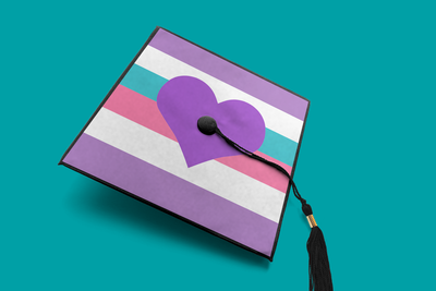 Grad cap with stripes and a large heart. The stripes are in the colors of a pride flag.