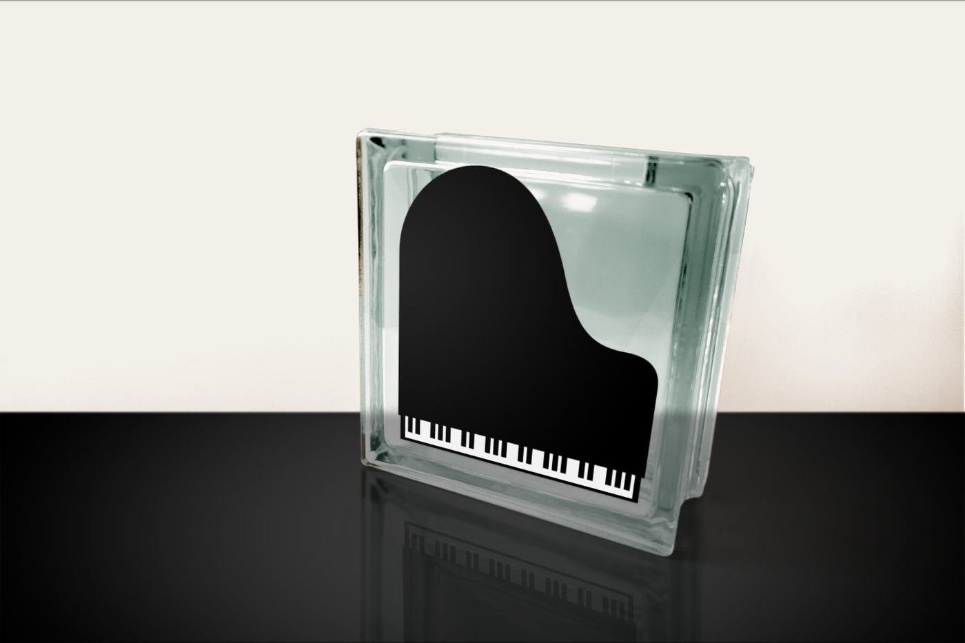 A glass block with a design of a top view of a grand piano.