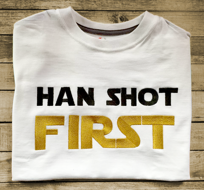 Folded tee with embroidered "Han Shot First" in black and gold