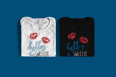Two folded tees. Each has a pair of lip prints and says "hello sweetie"