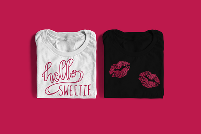 Two folded tees. One says "hello sweetie" and the other has a pair of lip prints.