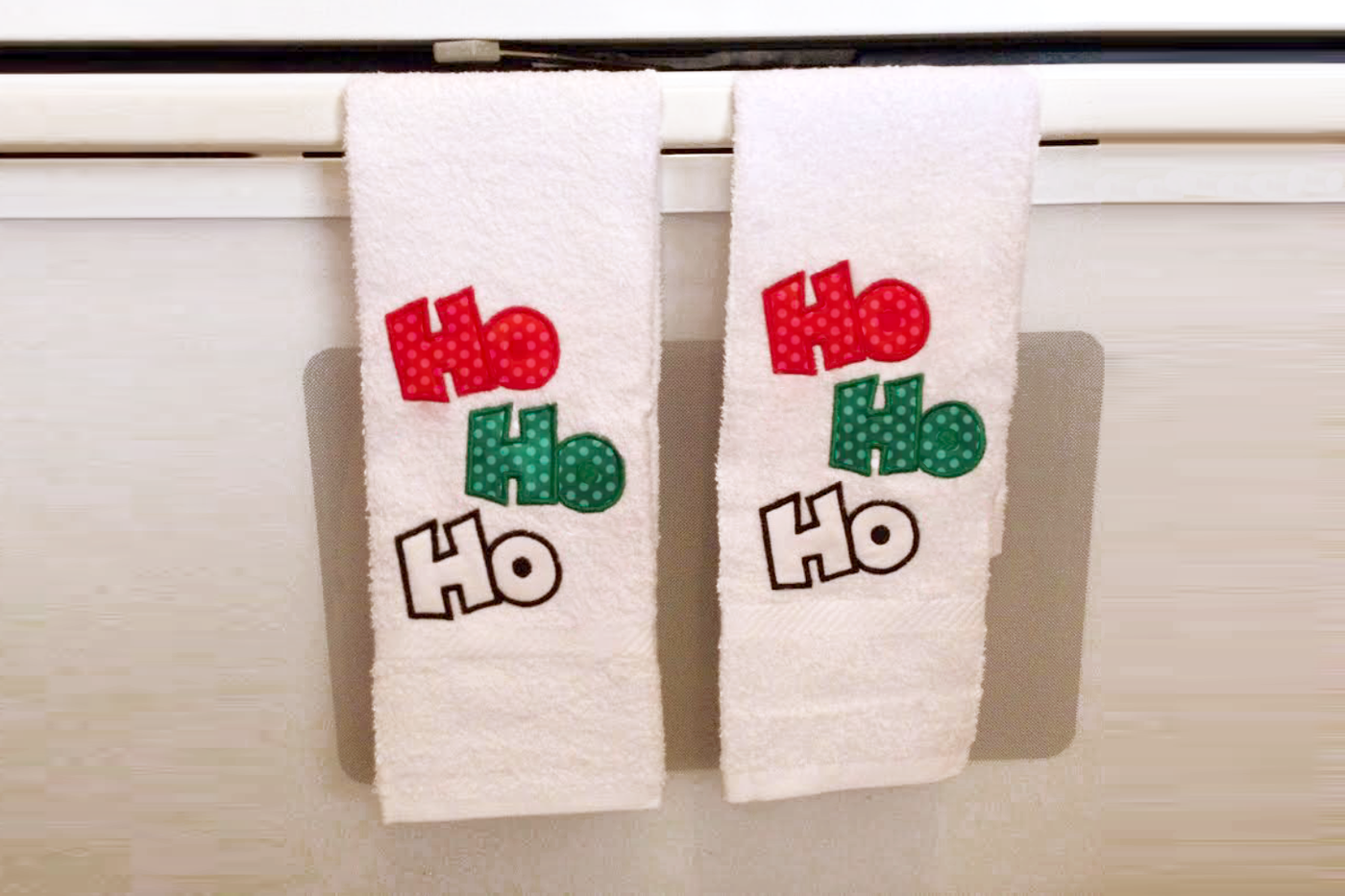 Applique of "Ho Ho Ho" with each Ho stacked vertically and staggered.
