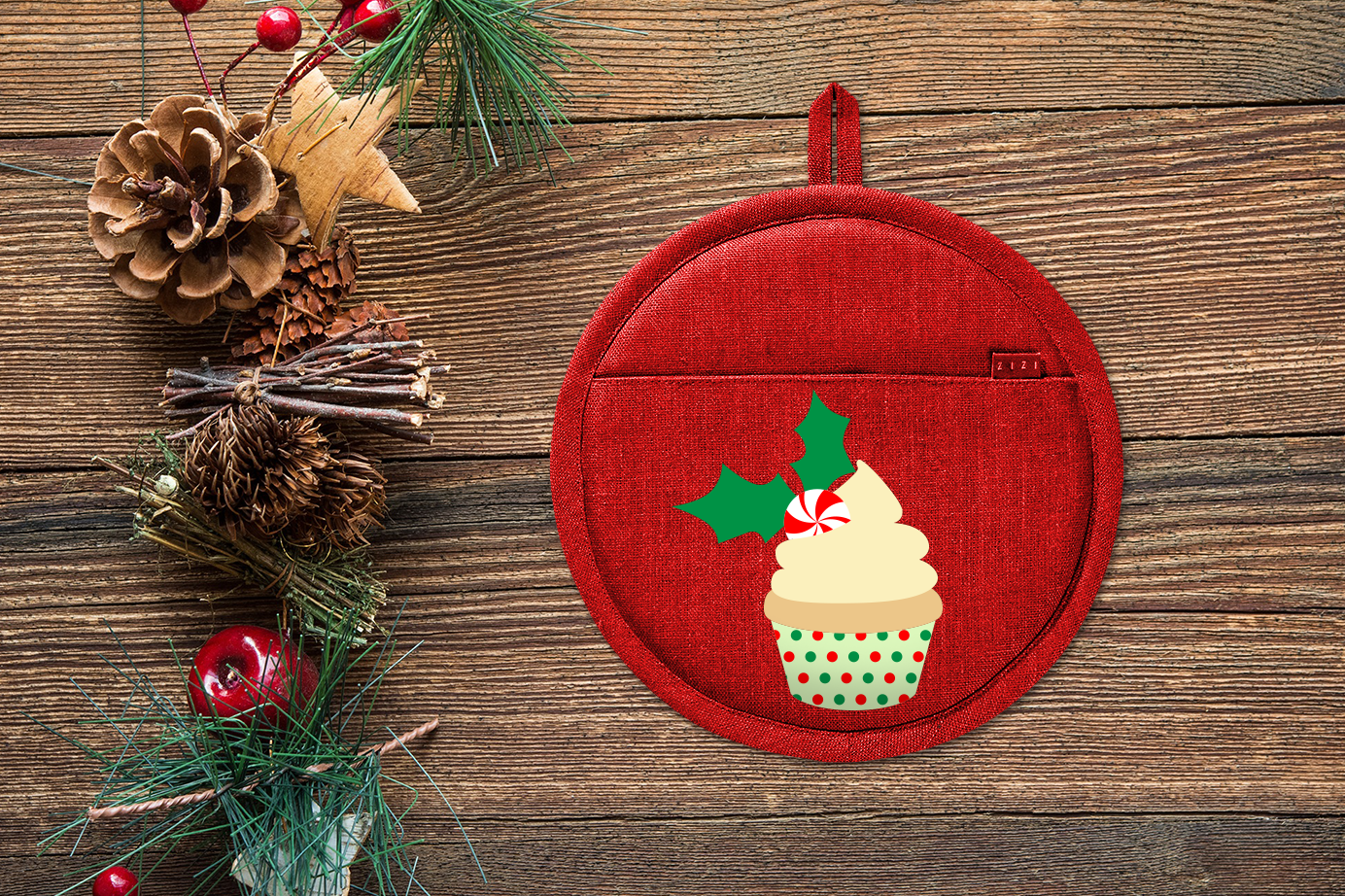 Pot holder with a cupcake design. The cupcake is decorated with holly, a peppermint, and a polkadot wrapper.