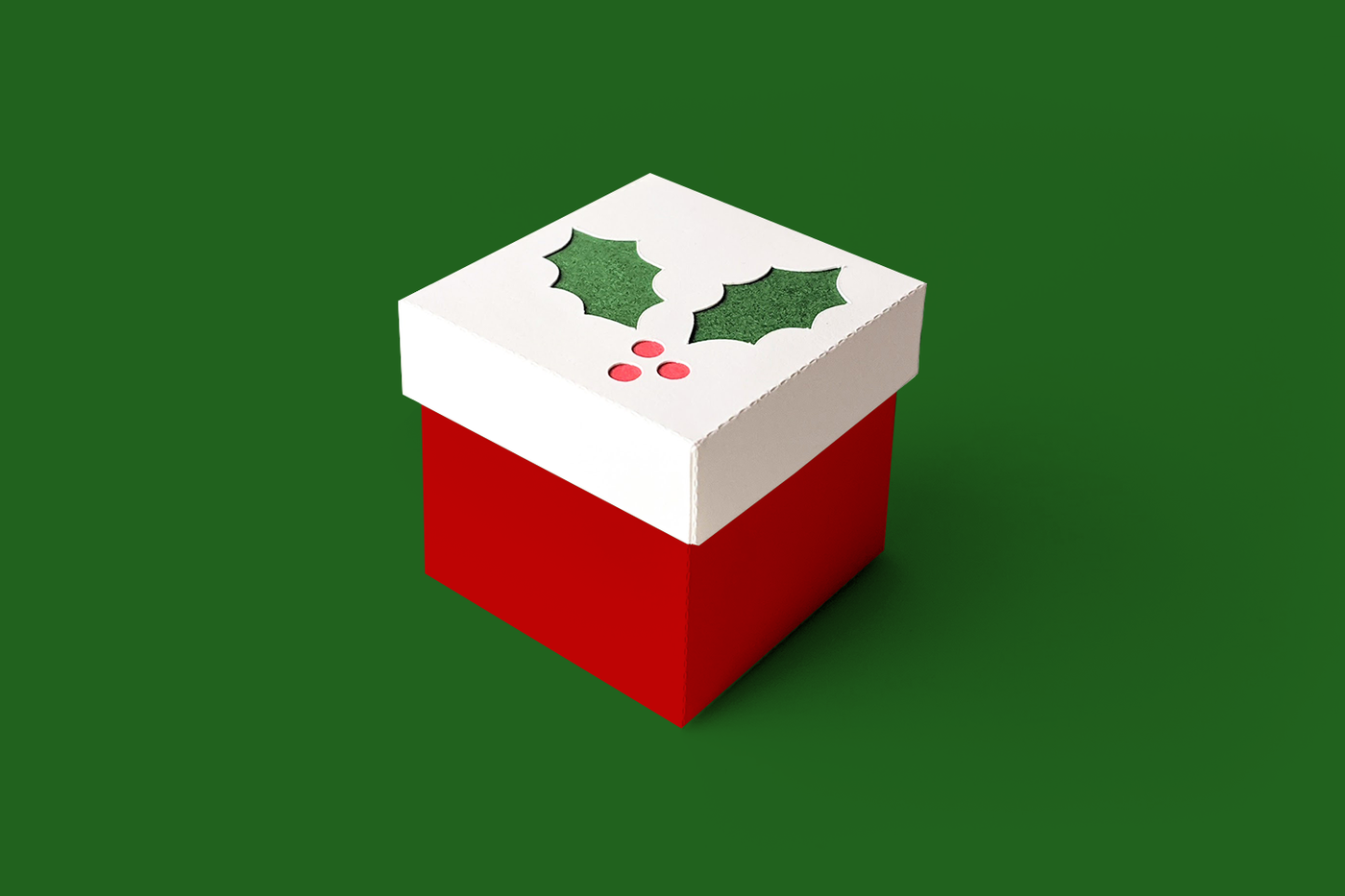 Christmas cube gift box with holly cutout in the lid