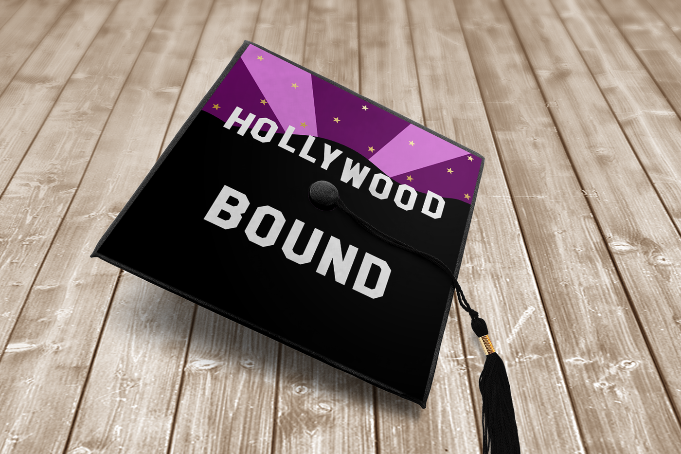 Graduation cap with design that says "Hollywood bound" with a starry night sky and hill silhouette.