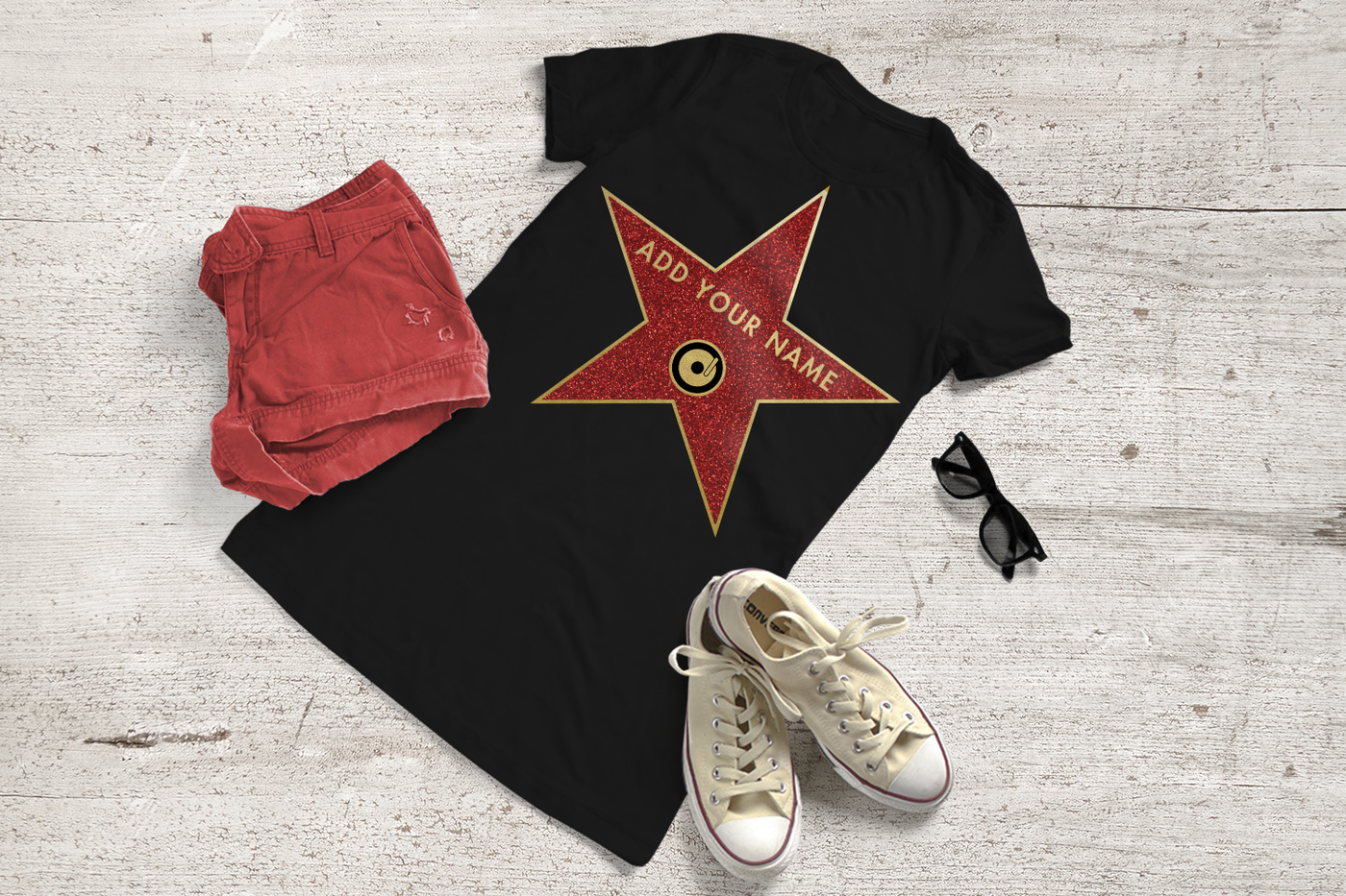 Black tee with a red and gold star. Center has a record icon and in gold it says "add your name."